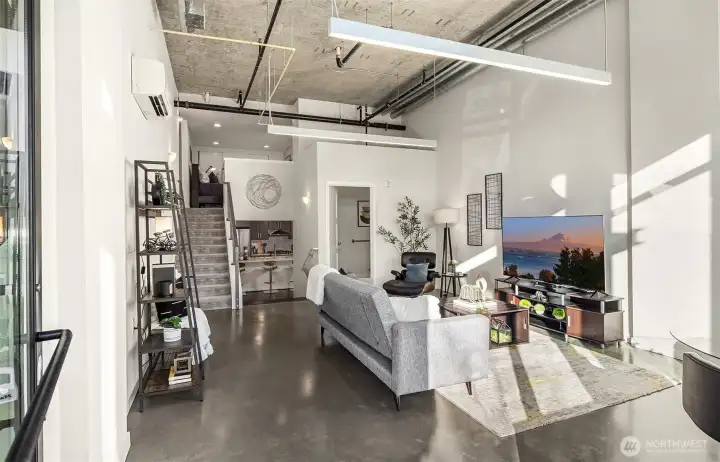 Sleek modern design with polished concrete floors, soaring ceilings and sunlit interior