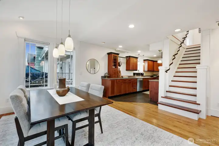 Wide staircase leads upstairs. Timeless kitchen with natural wood cabinets. Stainless steel appliances.