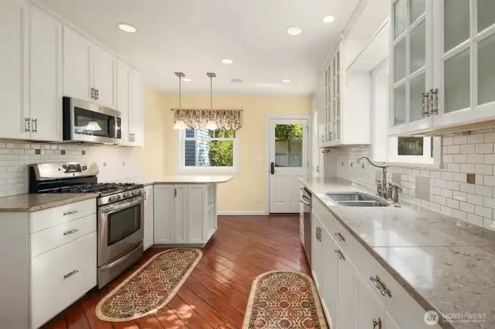 Kitchen with granite counters and tile backsplash