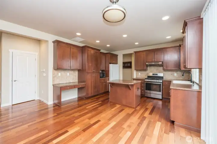 Full view of kitchen with eating bar and plenty of room for dining table and chairs.