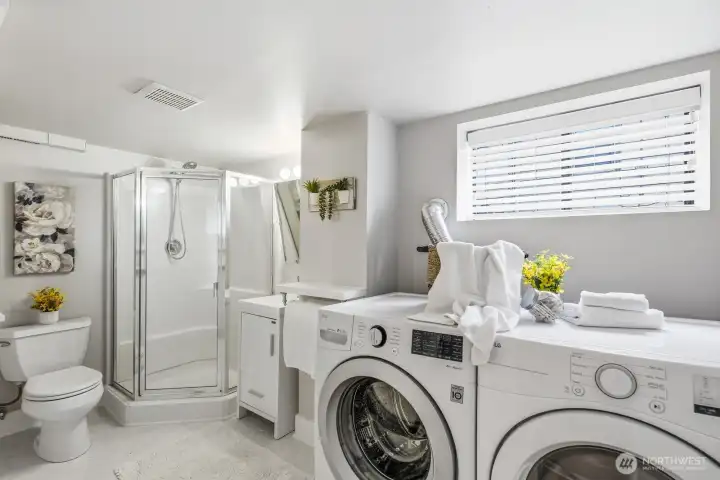 Three-quarter bathroom with laundry in basement.
