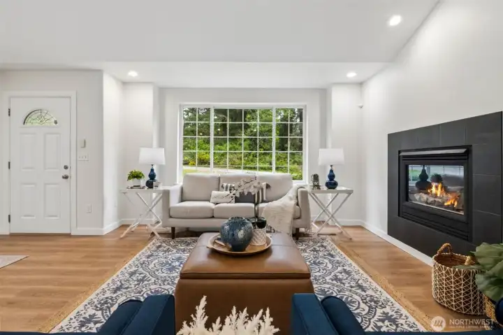 The living room offers a warm, welcoming atmosphere with its vaulted ceilings, abundant natural light and recessed lighting.