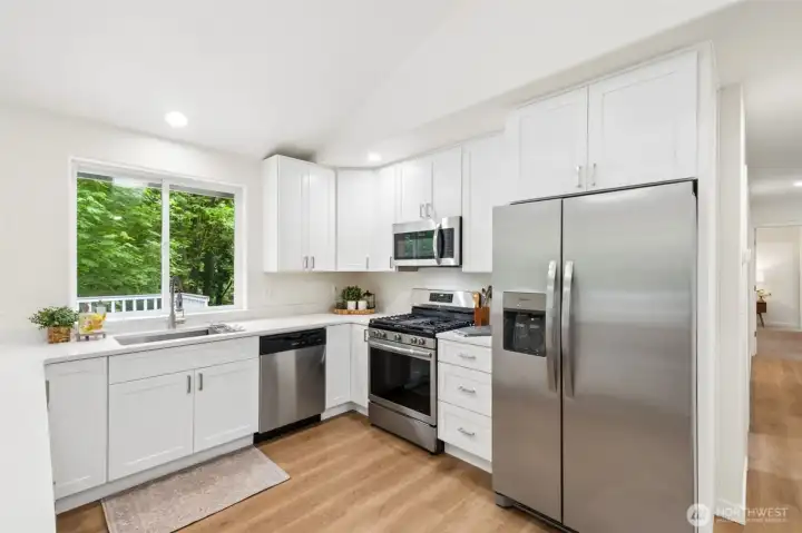 The brand-new kitchen is a true showstopper with soft-close white cabinetry and quartz countertops. Brand new Stainless steel appliances including a gas range/oven and a large eating bar make it both beautiful and functional.