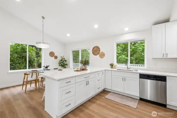 The brand-new kitchen is a true showstopper with soft-close white cabinetry and quartz countertops. Stainless steel appliances and a large eating bar make it both beautiful and functional.
