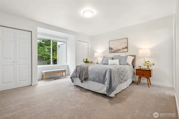 The primary suite is a peaceful retreat with French doors and soft new carpet underfoot. Three closets provide exceptional storage, a rare and welcome luxury all while enjoying serene Greenbelt views.