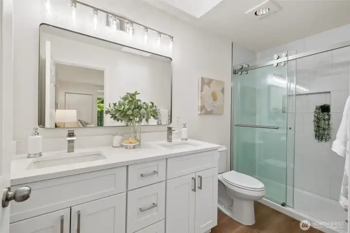 The fully remodeled primary en-suite bath offers modern finishes and a bright, refreshing feel. It’s the perfect place to start and end your day in comfort.