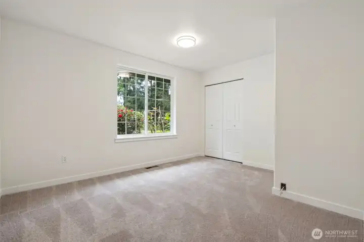 Secondary bedrooms feature fresh paint and plush carpeting for a cozy, restful atmosphere. Each room enjoys ample natural light and flexible layout options.