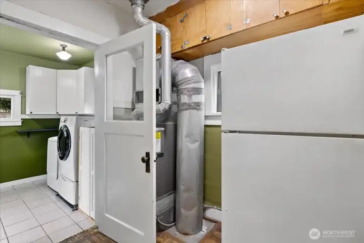 Furnace room with Fridge