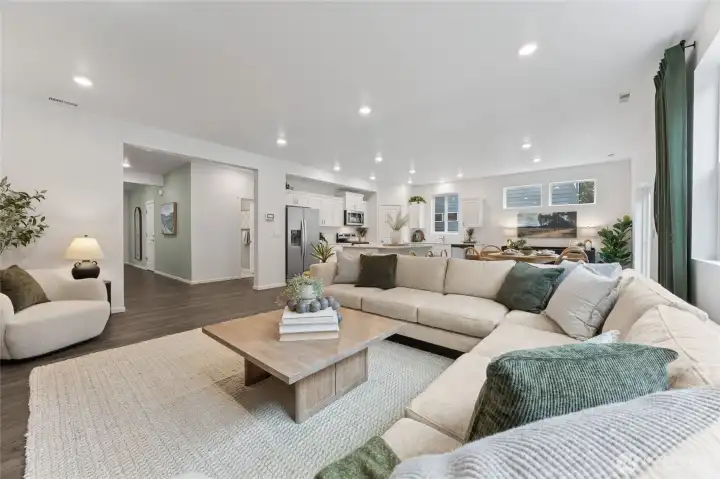 This sweeping view perfectly captures the open-concept main floor, where the great room flows effortlessly into the dining area and kitchen beyond. Photos are representative only and may display different colors and or upgrades.