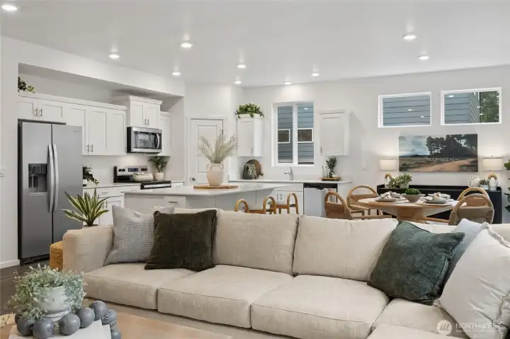 From the living room, the eye is drawn through the open-concept space into the chef-inspired kitchen. Photos are representative only and may display different colors and or upgrades.