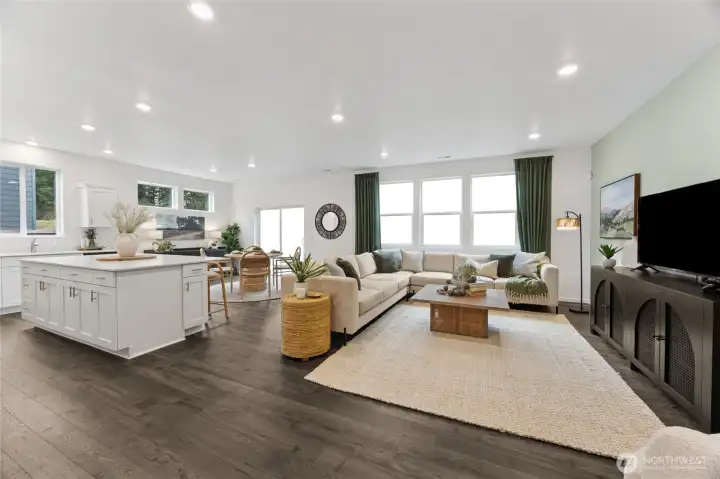 This expansive view of the open-concept main living area beautifully illustrates the flow between the kitchen island, dining space, and great room. Photos are representative only and may display different colors and or upgrades.