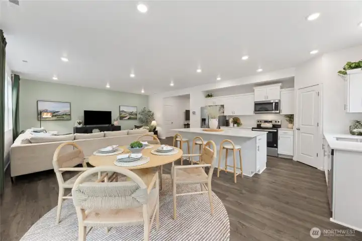 A reverse angle from the dining nook toward the great room and kitchen. Photos are representative only and may display different colors and or upgrades.