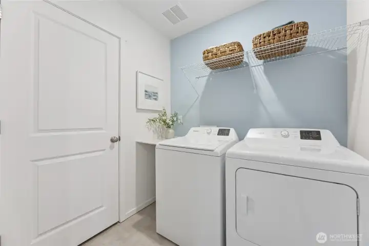 The dedicated laundry room is thoughtfully designed with plenty of space. Photos are representative only and may display different colors and or upgrades.