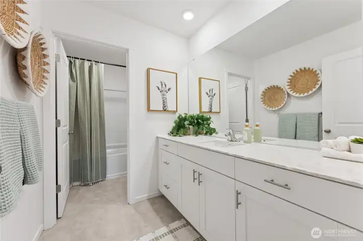 This beautifully styled full bathroom features dual sinks and quartz countertops. Photos are representative only and may display different colors and or upgrades.