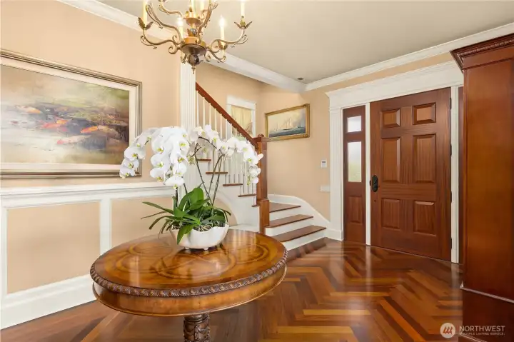 Looking from the living room to the front door and the stairs to the upper level.