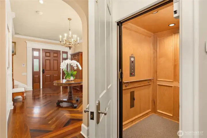 From the hallway looking toward the entry. The elevator is spacious with wood paneling