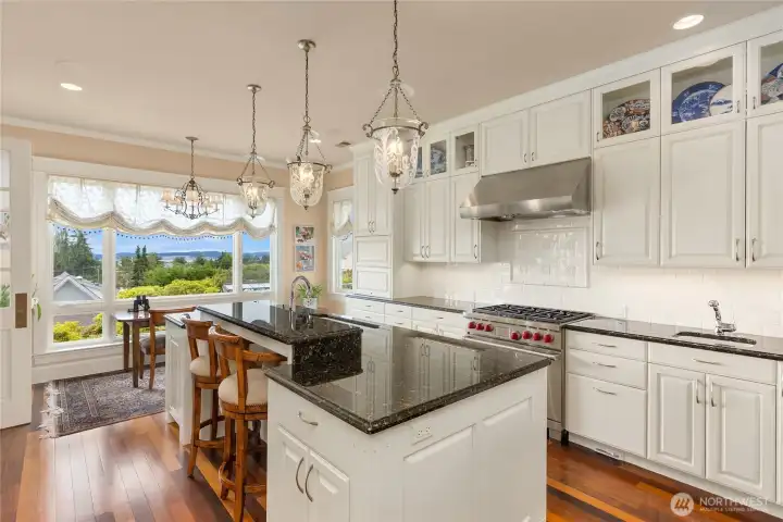 The chef's kitchen with eat-in space over looking the gardens and out to the stunning view