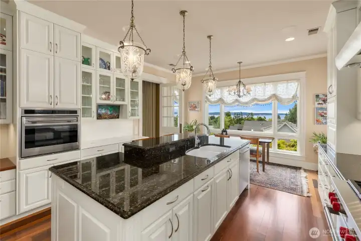 The kitchen has custom cabinetry, granite counters, high end appliances, two sinks and plenty of storage.