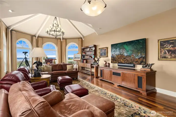 The library den on the upper level checks all the boxes- incredible woodwork and cabinetry, wet bar, fireplace, TV and a view to it all.