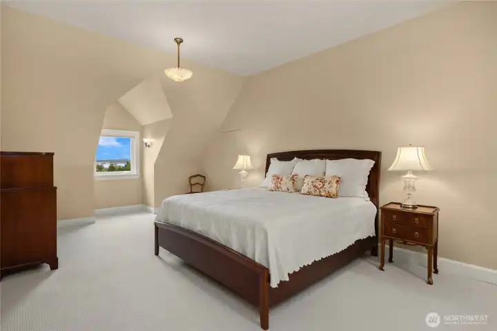 The second bedroom on the upper floor is larger with extra storage.