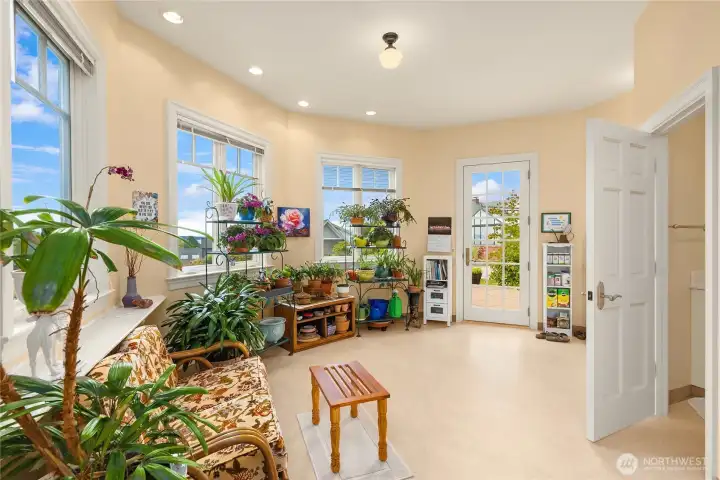 The lower level has a beautiful garden room that opens to the patio and yard and is close to the green house.
