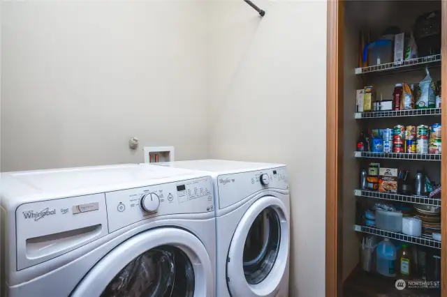 Right off the garage door entrance to the home is the laundry area, which ha an attached step-in pantry.