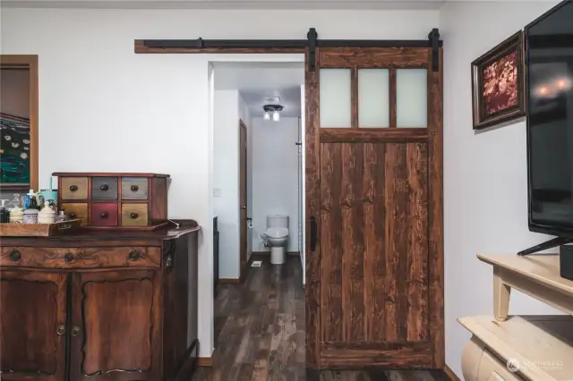 Gorgeous barn door accentuates the entrance to the ensuite bath.