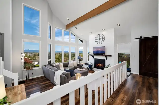 Gather ‘round the stately fireplace in a living room crowned with architectural drama—vaulted ceilings, rich light, and timeless charm.