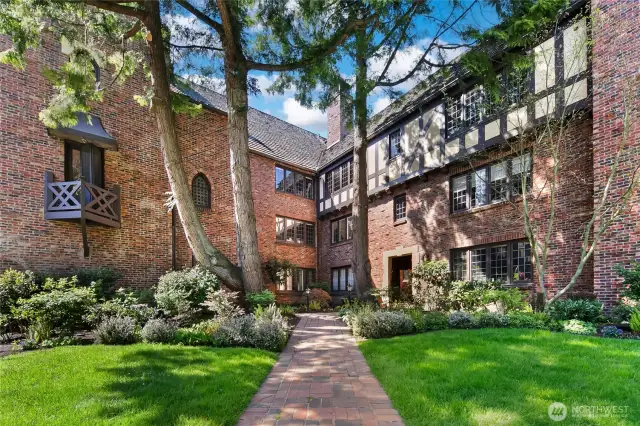 Landscaped courtyard with small lawn area is professionally maintained
