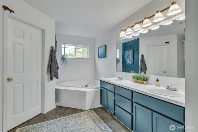 Primary bathroom with soaking tub and walk in closet