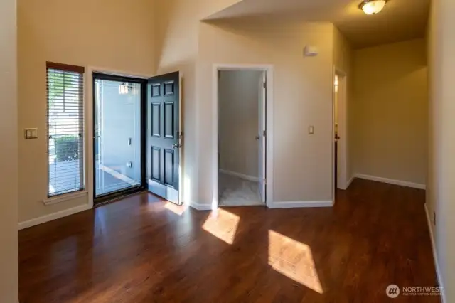 Step inside the entryway onto laminate wood floor with den right off the entry and overlooking the front.