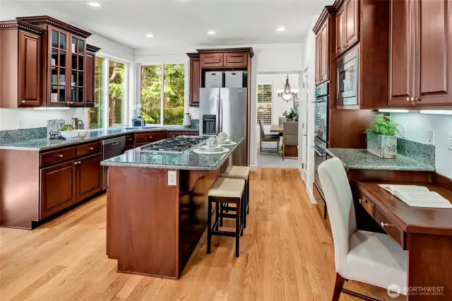 This expansive kitchen is a chef’s dream, featuring rich cherry cabinetry, granite countertops.