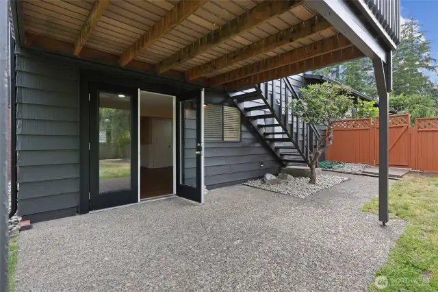 Out french doors from lower famliy room. Steps lead to deck above off living room