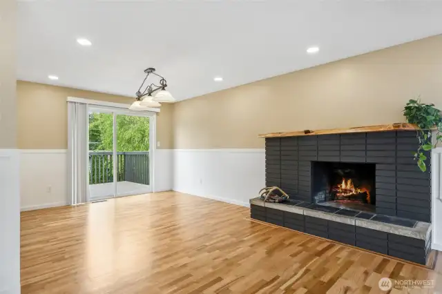 Check out these newly refinished hardwood floors! Gorgeous! Doors lead out to deck overlooking backyard and peek a boo view of water- great for entertaining.