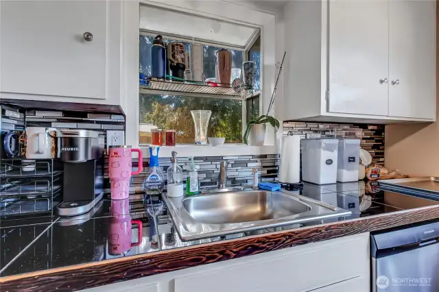 Stainless steel sink and beautiful tile backsplash.