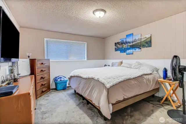 Primary bedroom with white wainscotting.