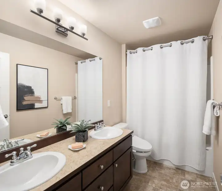 Upstairs bath with dual sinks.