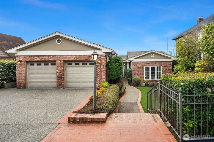 Large two-car, attached garage. Level entry to inside. Notice plenty of driveway space for guests.