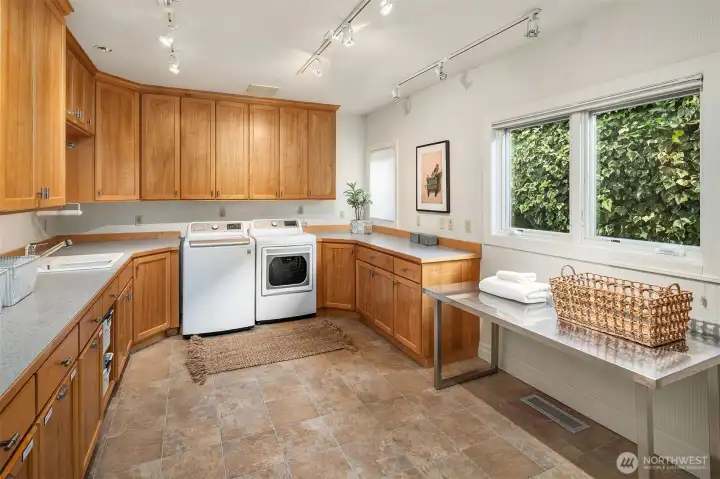 Main Floor expansive Laundry Room with extra storage cabinetry.