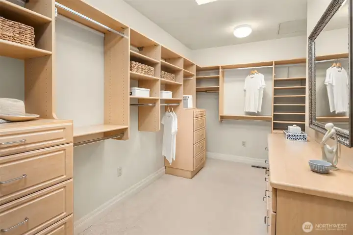 Primary closet with more around the right.