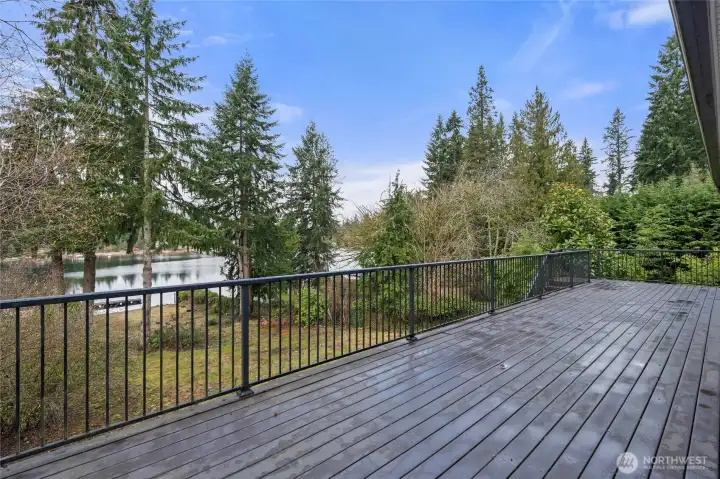 Back of home Trex composite decking overlooking view of the lake and private dock.