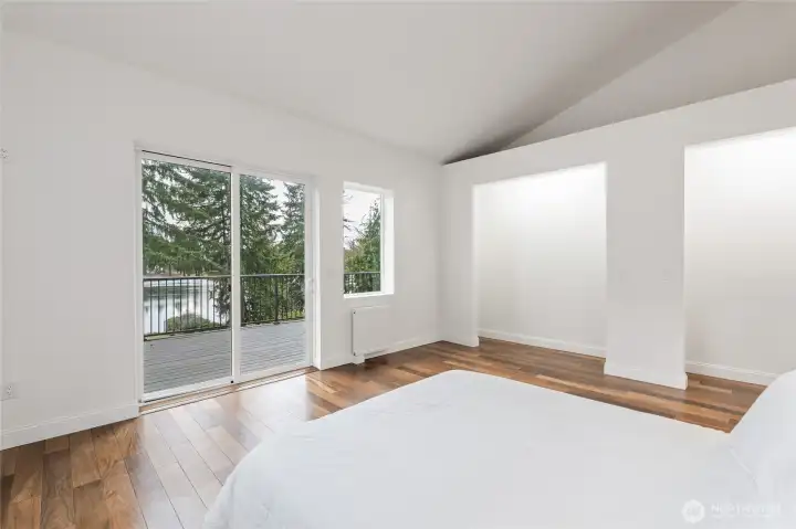 Primary Bedroom: two extra-tall closet spaces with inside lighting. Additional storage space above closet areas. Morning lake views.