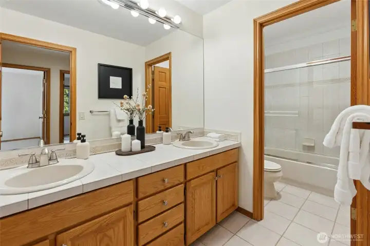 Shared hall bath with dual sinks.