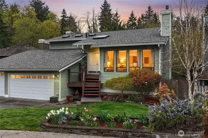 Welcome home to a beautifully landscaped yard and inviting windows.