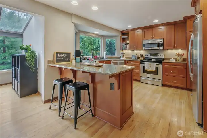 Eat-in kitchen, under cabinet lighting, and stainless appliances.