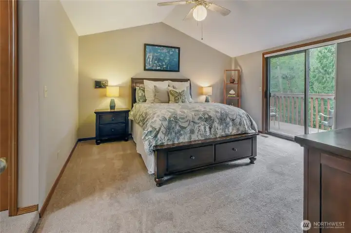 Primary bedroom with en suite and balcony over the hot tub.