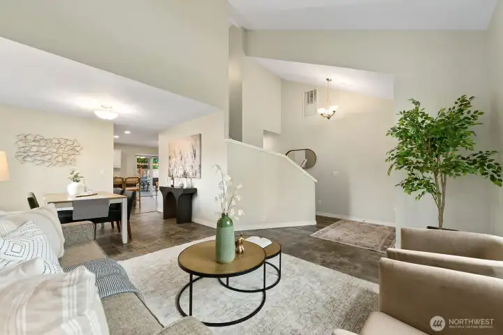 Open-concept living, dining & staircase showcase this home's airy layout. Open-concept living, dining & staircase showcase this home's airy layout.