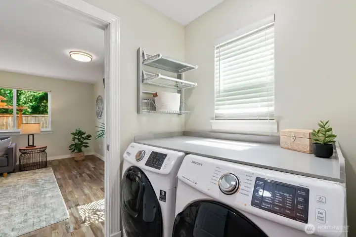 Laundry room with Samsung front-loaders, folding counter & drying rack. Laundry room with Samsung front-loaders, folding counter & drying rack.