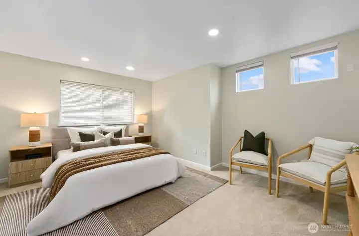 Generous primary suite with plush carpet, sky views & space to lounge. Generous primary suite with plush carpet, sky views & space to lounge.