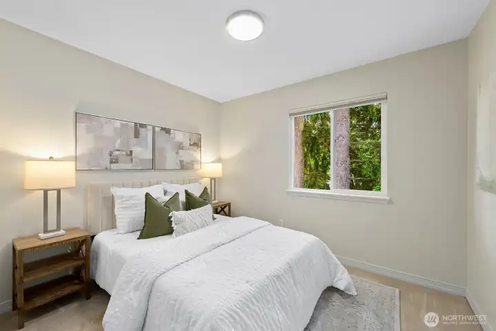Serene secondary bedroom with plush carpet & tranquil tree views. Serene secondary bedroom with plush carpet & tranquil tree views.